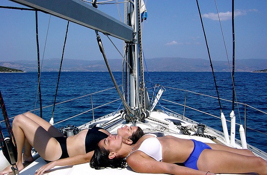 two rich girls suntanning on a yacht