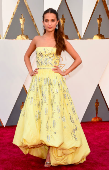 Alicia Vikander in a yellow dress by Louis Vuitton at the Oscars 2016 red carpet